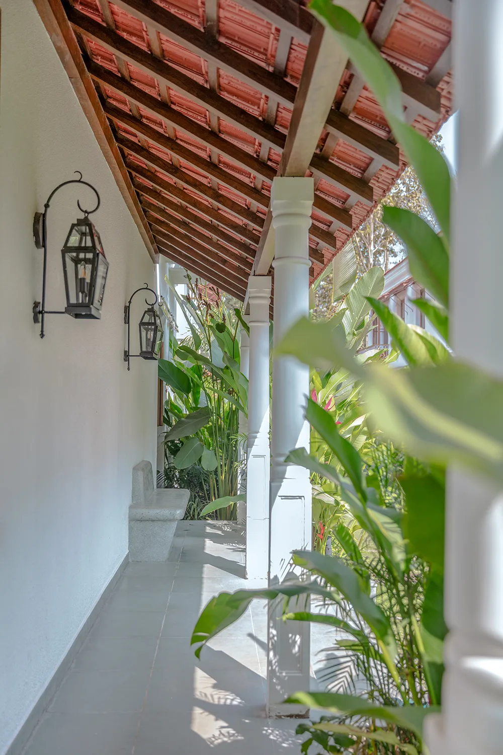 Covered verandah overlooking the pool at a villa in Assagao